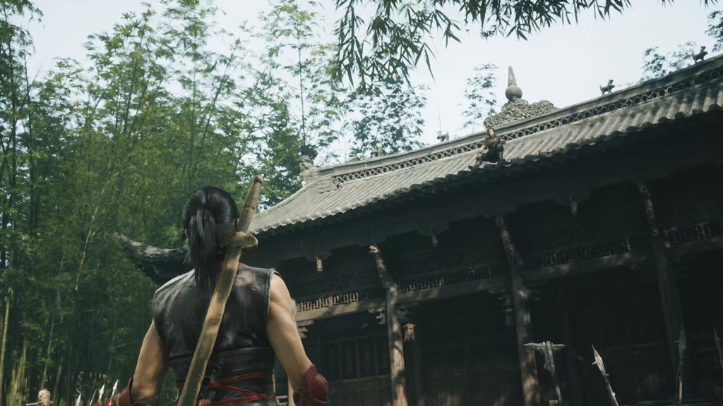A Chinese courtyard surrounded by bamboo forest, a figure seated on the roof ridge, weapon racks in the yard and a sword-carrying warrior seen from behind
